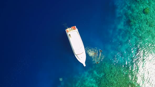 Aerial drone texture of coastline beach by blue ocean with sand background