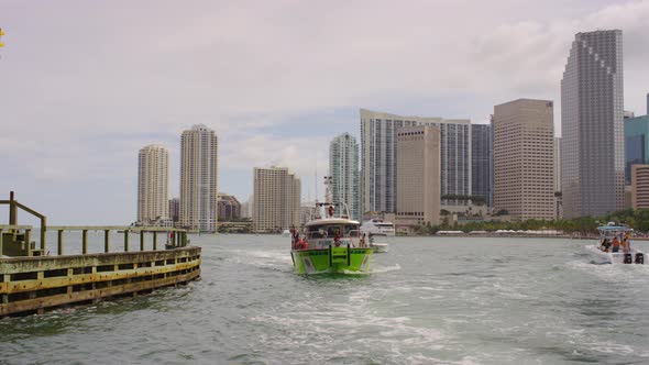 Green boat sailing in Miami alt