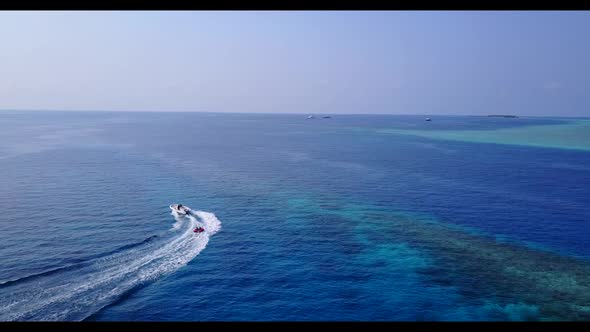 Aerial seascape of perfect island beach time by blue water with white sand background of a daytrip n