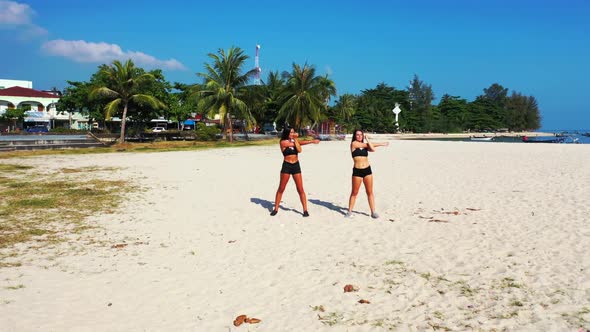 Women enjoying life on perfect sea view beach lifestyle by blue ocean and white sand background of T