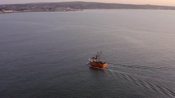 Fishing Boat at Sunrise out at Sea