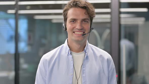 Portrait of Man with Headset Smiling At Camera