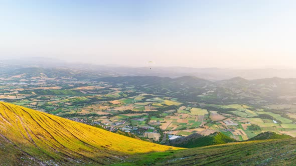 PAN: aerial view at sunset in Umbria region, Italy. Summer green valley unique hills and mountains l