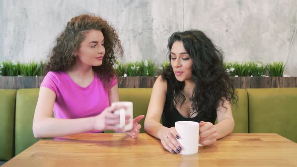 Female Friends Drinking Coffee in Cafe