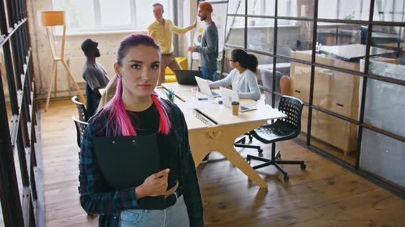 Young Creative Office Worker Looking at Camera Brainstorming Meeting on Background Tracking Shot