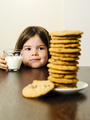 Young girl staring at pile of cookies - PhotoDune Item for Sale