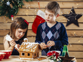 Brother and sister decorating gingerbread house - PhotoDune Item for Sale