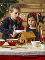 Brother and sister decorating gingerbread house - PhotoDune Item for Sale