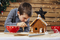Young boy decorating gingerbread house - PhotoDune Item for Sale