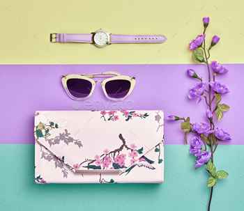  minimal colorful flat lay. Trendy handbag clutch, luxury sunglasses. Floral spring style. Creative layout