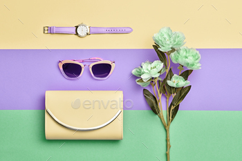 imal Style, flat lay. Trendy fashionable Yellow Handbag Clutch, Glamour Sunglasses. Green Flower. Luxury Spring lady