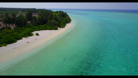 Aerial top down seascape of exotic island beach lifestyle by blue lagoon and white sand background o