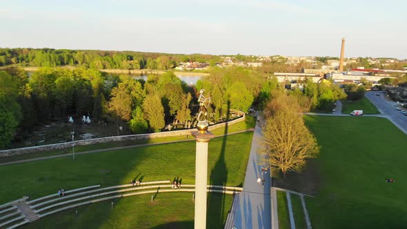 Aerial Circle Around Golden Boy Monumnet In Siauliai