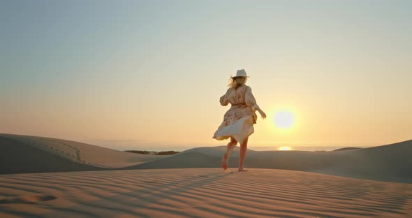 Inspirational  of Model in Safari Clothes. Woman Running Toward the Sunset