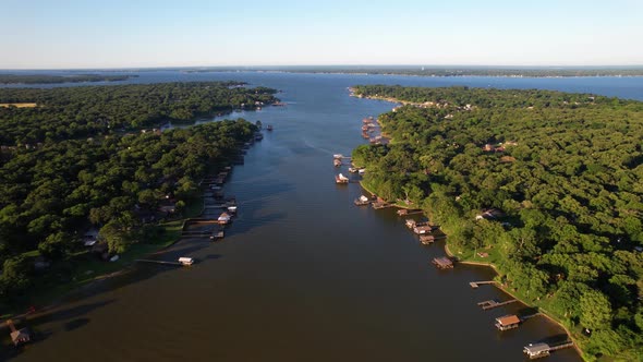 Aerial footage of Cedar Creek Lake in Texas on the east side flying west.