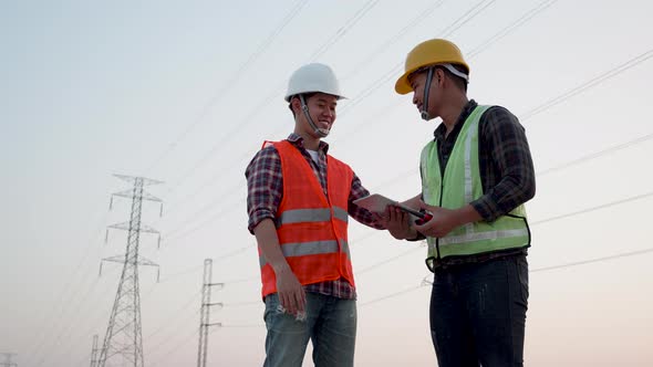 Teamwork industry a concept. Two men working on the power plant.