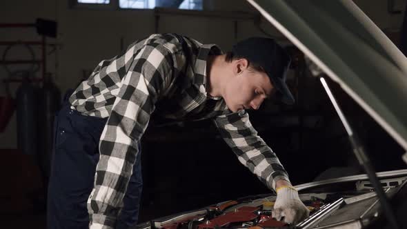 Car Service Repair Maintenance and People Concept Mechanic Man Wearing Work Robe and Cap with Gloves