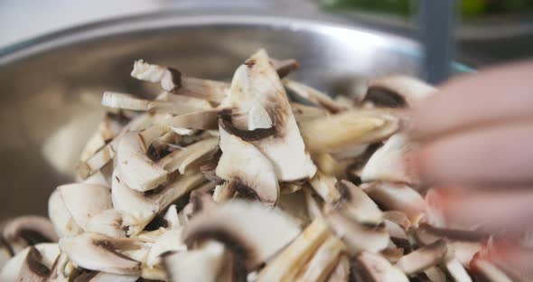 Chef Slicing Mushrooms in Kitchen