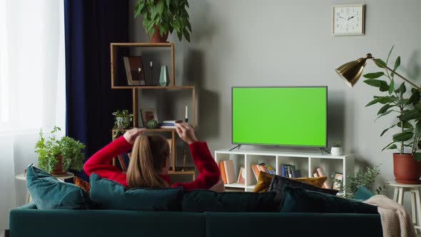 Woman Watching Television with Green Screen