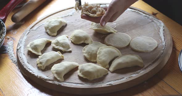 The raw traditional Ukrainian hand-made vareniki (dumpling) with cabbage inside