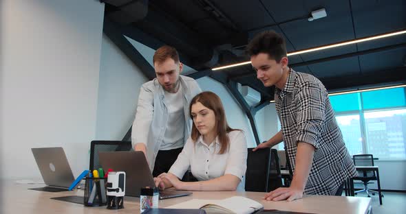 Employees Give Instruction to a Junior Employee