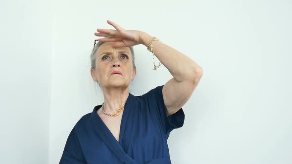 Female Portrait of Beautiful Old Grandmother with Grey Hair and Face with Wrinkles is Grimacing