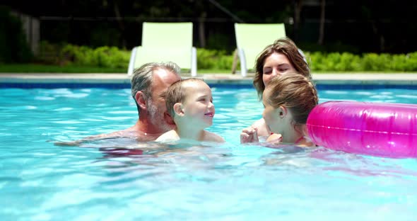 Family enjoying in swimming pool