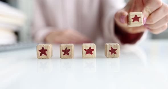 The Hand Puts the Cubes in a Row on the Table Five Stars