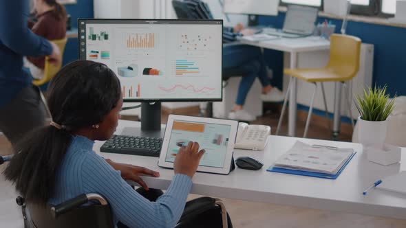 Black Woman Entrepreneur with Locomotor Disabilities Using Tablet and Pc