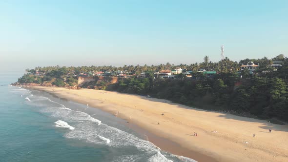 Varkala Beach, unique palm-covered red cliffs. Paradisiac sand beach, Kerala, India