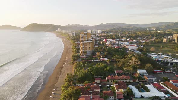 Seaside town of Jaco along the beautiful, tropical coast of Costa Rica at sunset. Wide angle aerial