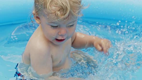 Cute Little Child Bathing in Blue Street Pool in Courtyard. Portrait of Joyful Toddler, Baby. Kid