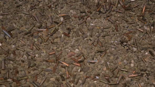 Many Empty Spent Cartridges in a Dash on Stones