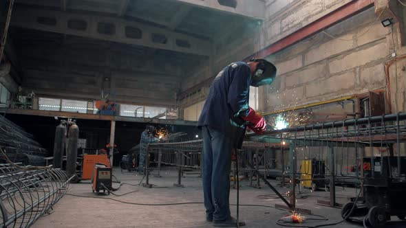 Metalworker workers weld metal in a welding workshop