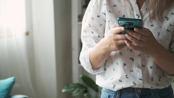 Woman Hands Texting Message on Mobile Phone at Home Close Up