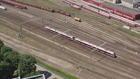 Passenger Train On Railroad Leaving the City