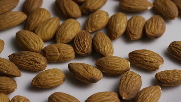 Cinematic, rotating shot of almonds on a white surface - ALMONDS 008