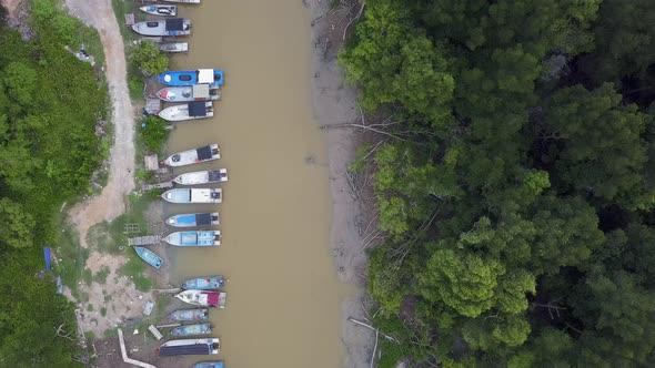 Aerial top down view fishing boats park near river