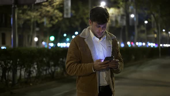 Positive Man Browsing Social Media in Evening
