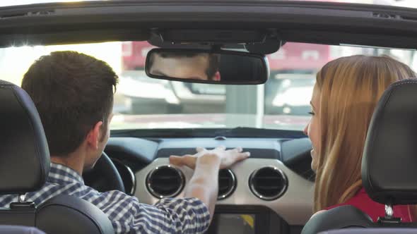 Happy Young Couple Smiling Joyfully Showing Car Keys To Their New Confertible