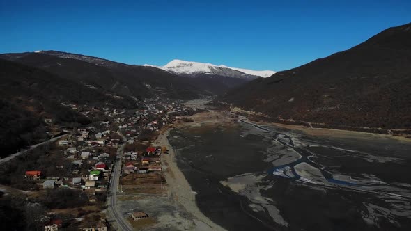 Aerial Motion of Village Between Mountains.