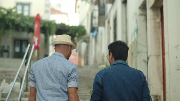 Back View of Male Gay Couple Walking Around City and Talking