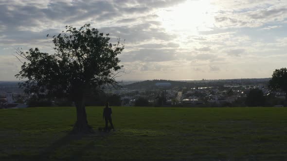 Panning Aerial Shot of Woman Relaxing in Nature Enjoying Sunset