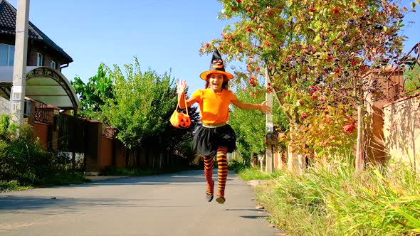 Child Girl in Costume Celebrates Halloween