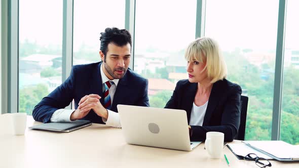 Two Happy Business People Celebrate at Office