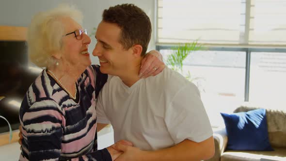 Mother and son dancing together in living room 4k