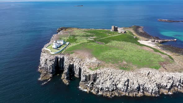 Aerial footage of the seaside coastal town of the village of Seahouses in the UK