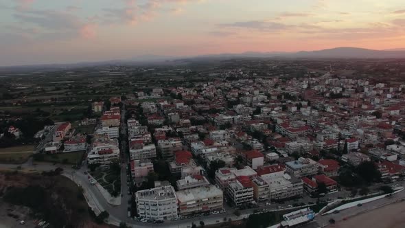  - Flying Over the Houses Rooftops in Coastal Town, Sunrise Scene. Nea Kallikratia, Greece