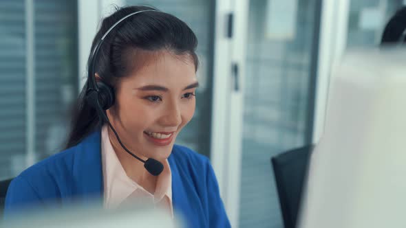 Businesswoman Wearing Headset Working Actively in Office