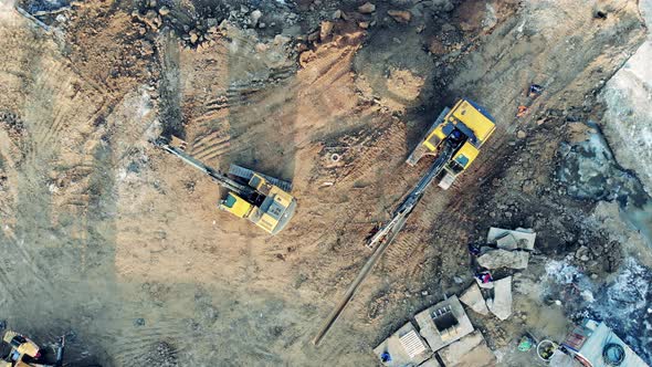 Two Excavators Drive on a Career with Earth. Construction Equipment, Heavy Industry Machinery. alt